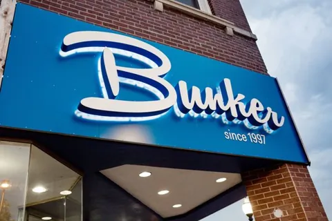 Illuminated sign face mounted above a business entrance