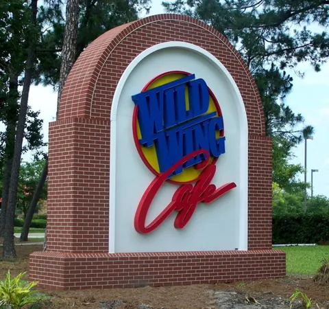 Brick monument sign with a colorful dimensional business logo